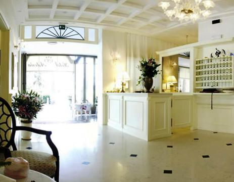 un grand salon avec une table et une chaise dans l'établissement Hotel Astoria, à Bibione