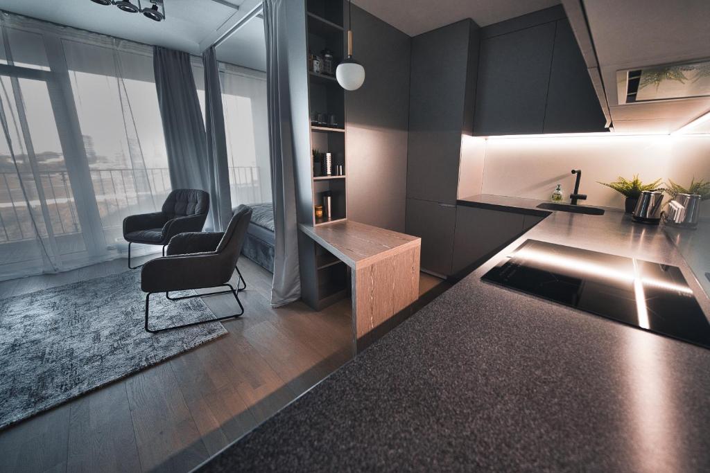 Modern central Riga apartment with balcony, gym access, dedicated parking, kitchen & AC 2