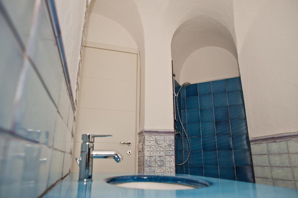 une salle de bain avec un lavabo et une douche dans l'établissement Le Ville Le Saline, à Palau