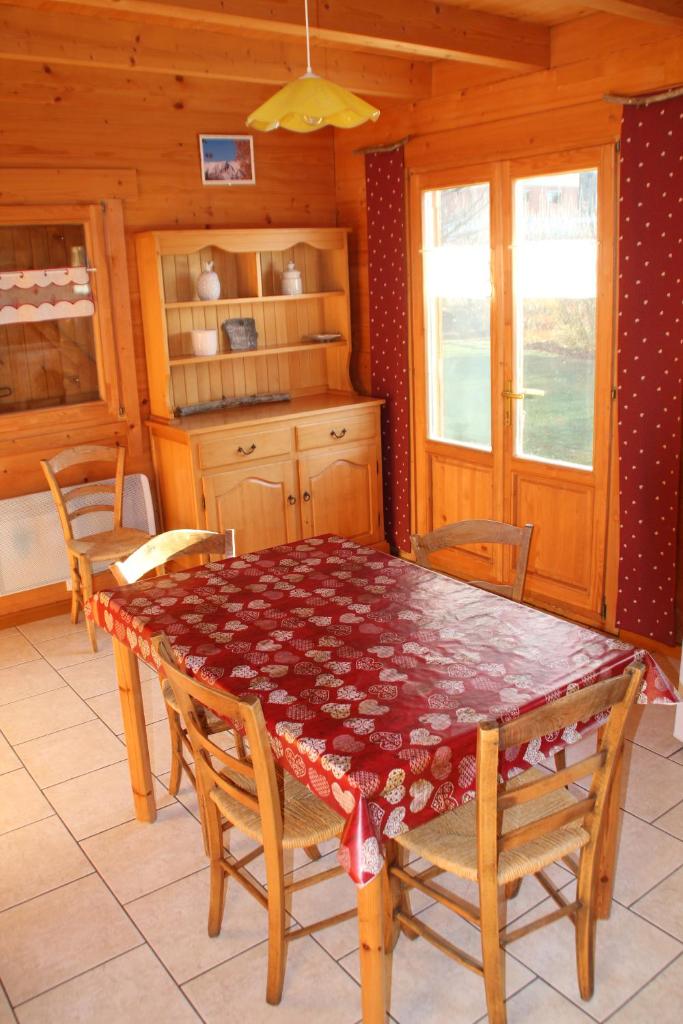 une salle à manger avec une table et des chaises dans une cabine dans l'établissement chalets de combebelle, à Saint-Léger-les-Mélèzes