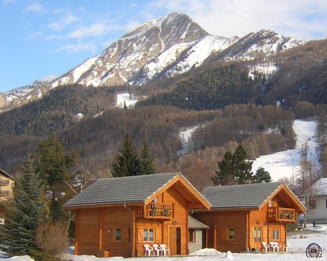 une cabane en rondins avec une montagne en arrière-plan dans l'établissement chalets de combebelle, à Saint-Léger-les-Mélèzes 7 autres photos