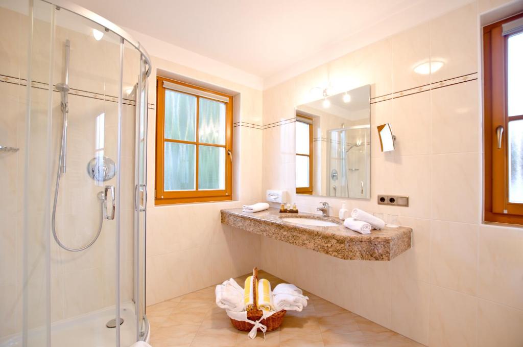 une salle de bain avec douche et lavabo dans l'établissement Hotel Weihrerhof, à Soprabolzano