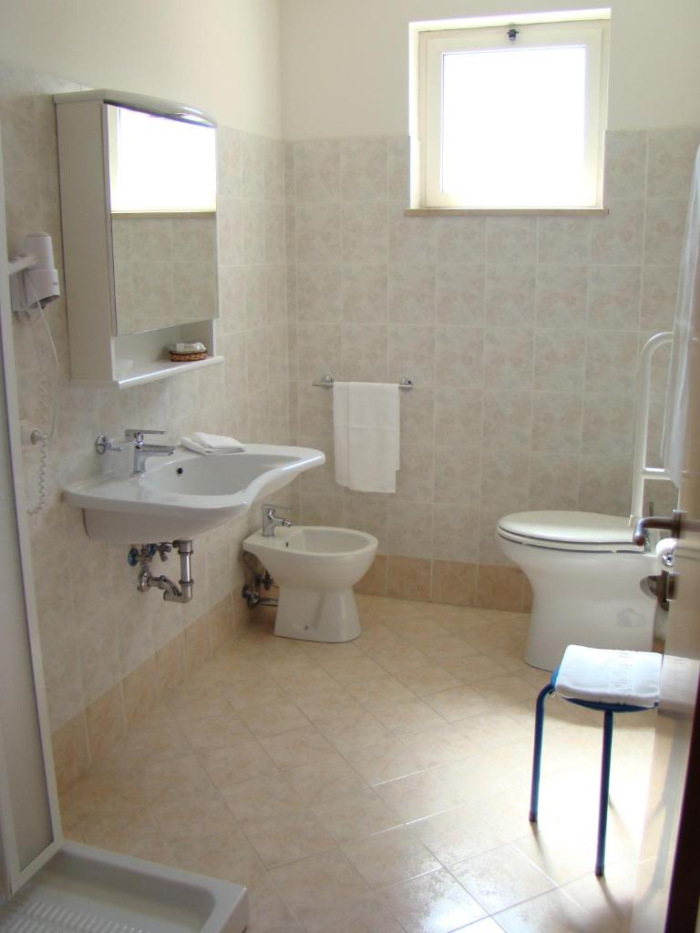 une salle de bain avec un lavabo et des toilettes dans l'établissement Il Casale, à Martinsicuro 25 autres photos