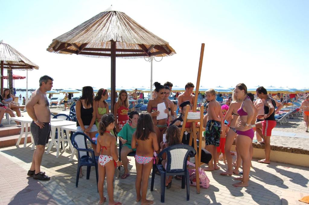 Un groupe de personnes debout sur la plage dans l'établissement Bikini Tropicana Family Hotel, à Lido di Savio 43 autres photos