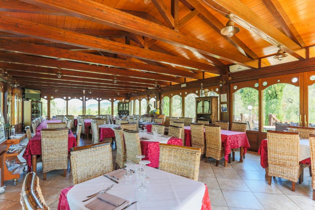une salle à manger avec tables, chaises et fenêtres dans l'établissement Tenuta Padre Pio, à Vieste