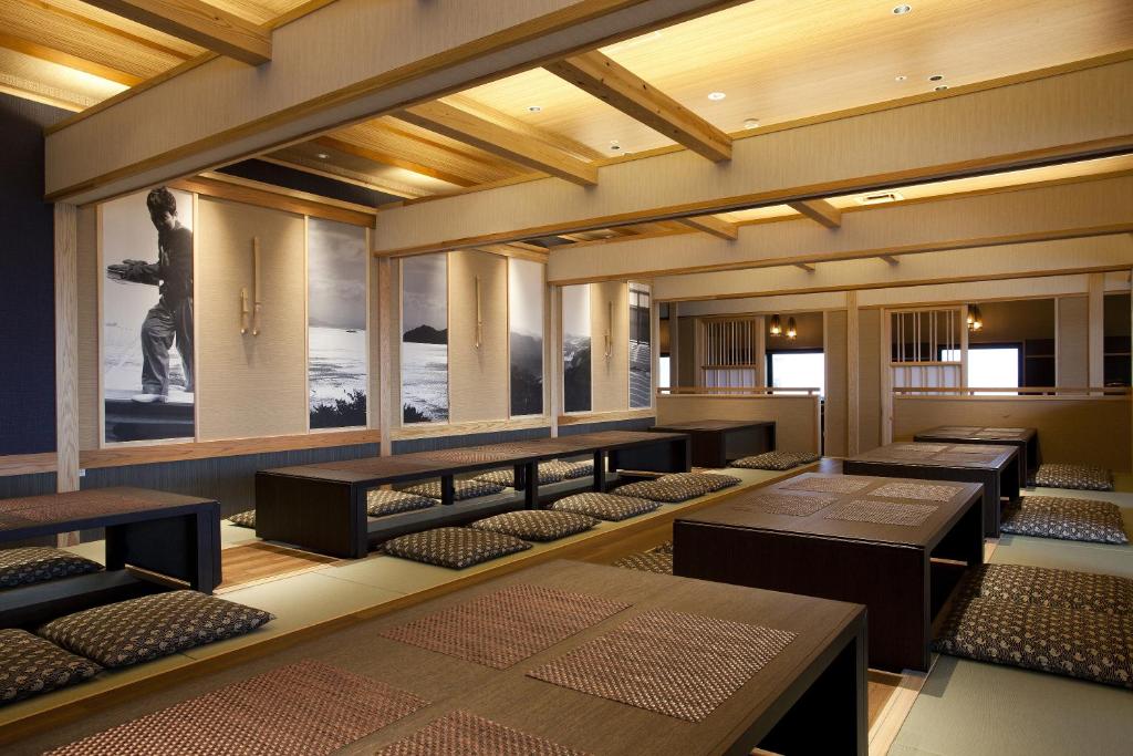 une chambre avec rangées de tables, de bancs et de fenêtres dans l'établissement Hanagoyomi, à Sumoto