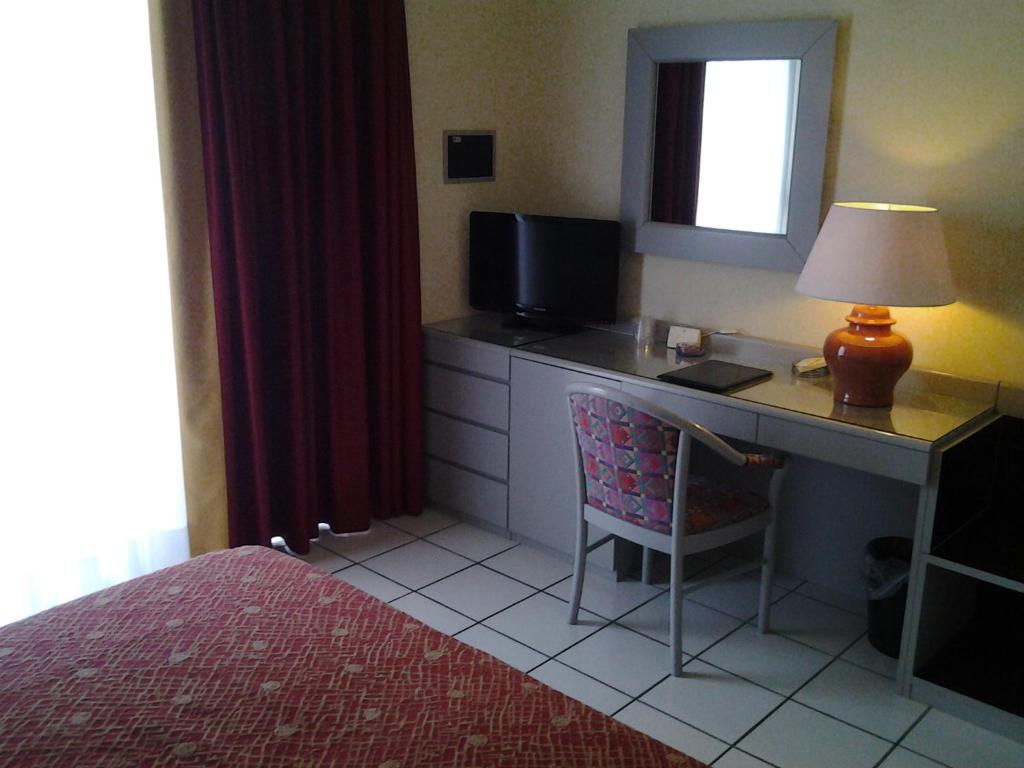 - une chambre avec un bureau, un ordinateur et une lampe dans l'établissement Hotel Principe Palace, à Lido di Jesolo