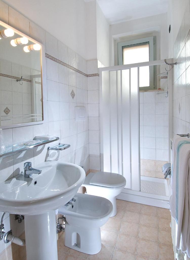 une salle de bain blanche avec un lavabo et des toilettes dans l'établissement Beaurivage, à San Benedetto del Tronto