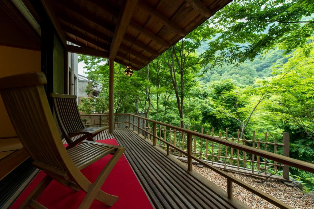 une terrasse couverte d'une maison avec un banc sur un balcon dans l'établissement Fujiiso, à Takayama
