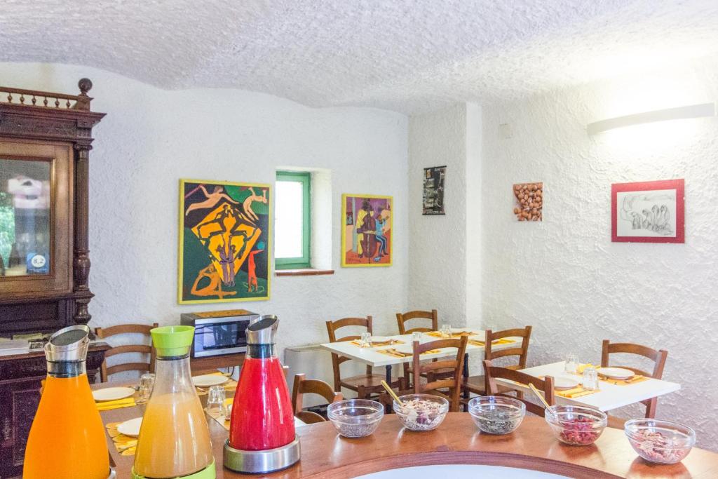 a dining room with tables and chairs and colorful bottles at Casa Del Noce in Rovereto