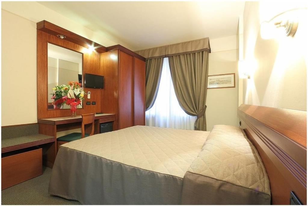 Posteľ alebo postele v izbe v ubytovaní Hotel Arcadia