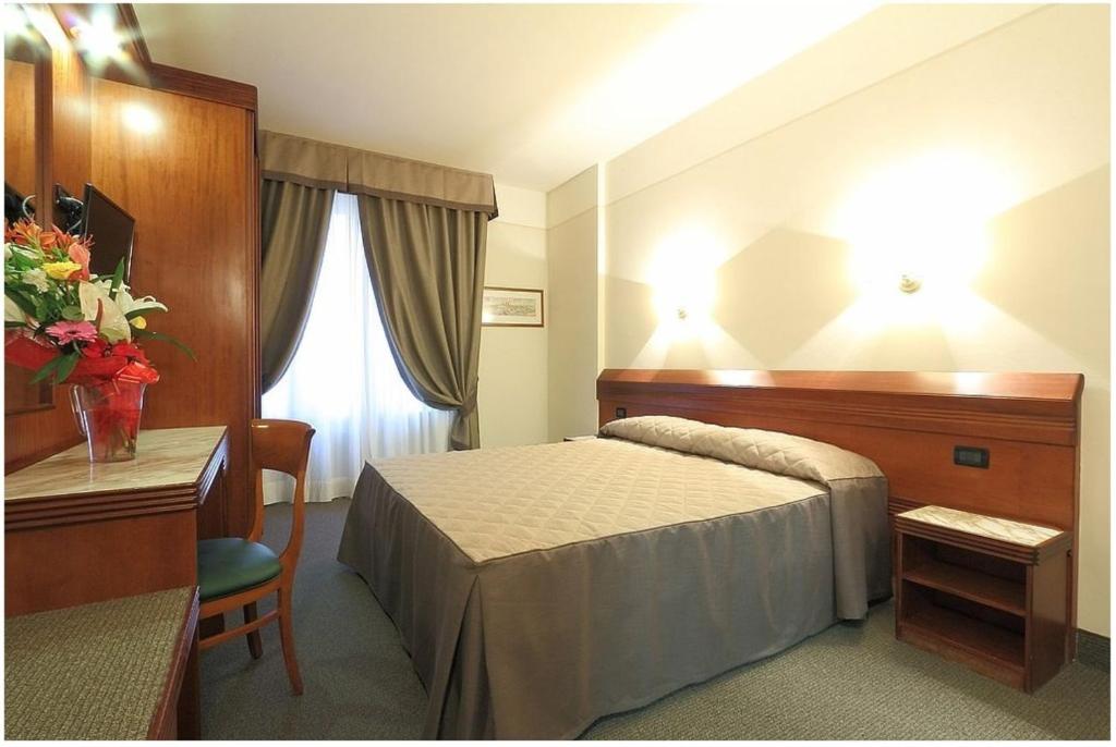 Posteľ alebo postele v izbe v ubytovaní Hotel Arcadia