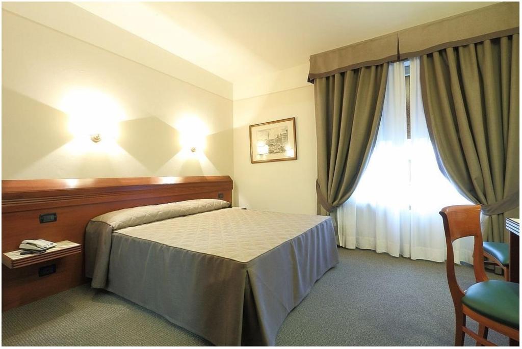 Posteľ alebo postele v izbe v ubytovaní Hotel Arcadia