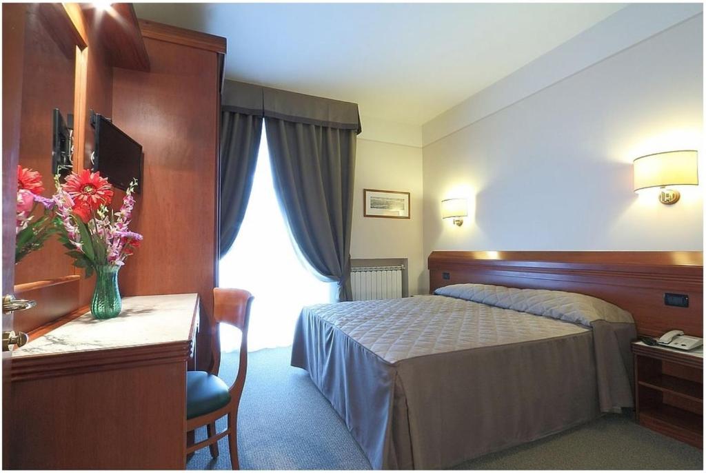 Posteľ alebo postele v izbe v ubytovaní Hotel Arcadia