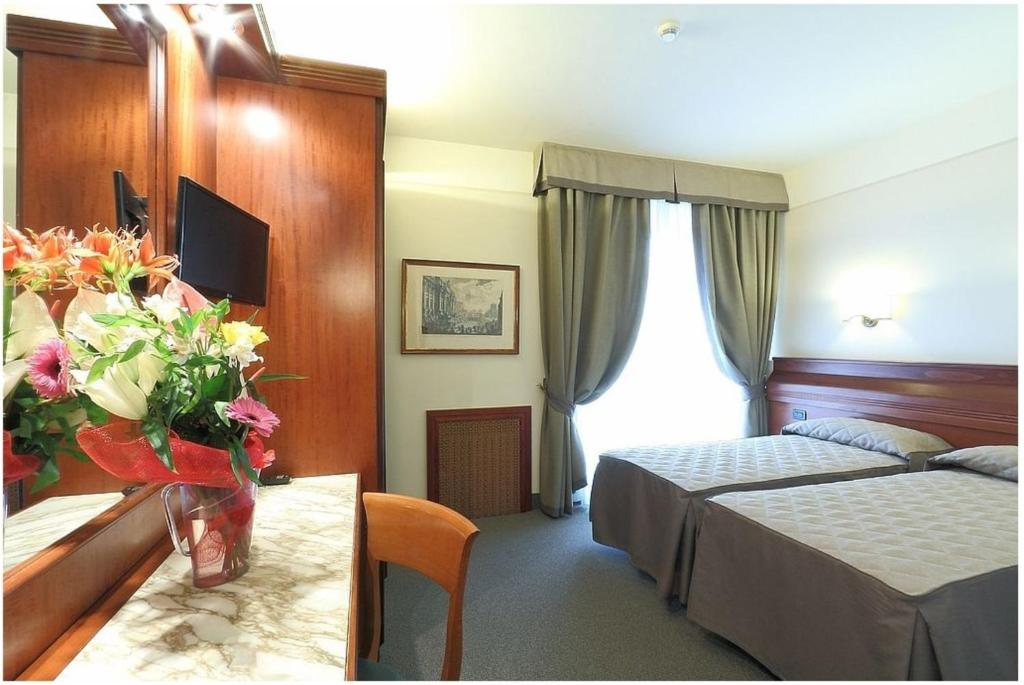 Posteľ alebo postele v izbe v ubytovaní Hotel Arcadia