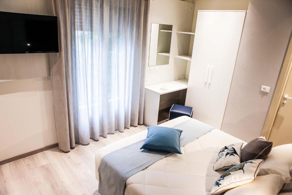Postel nebo postele na pokoji v ubytování Hotel Veliero
