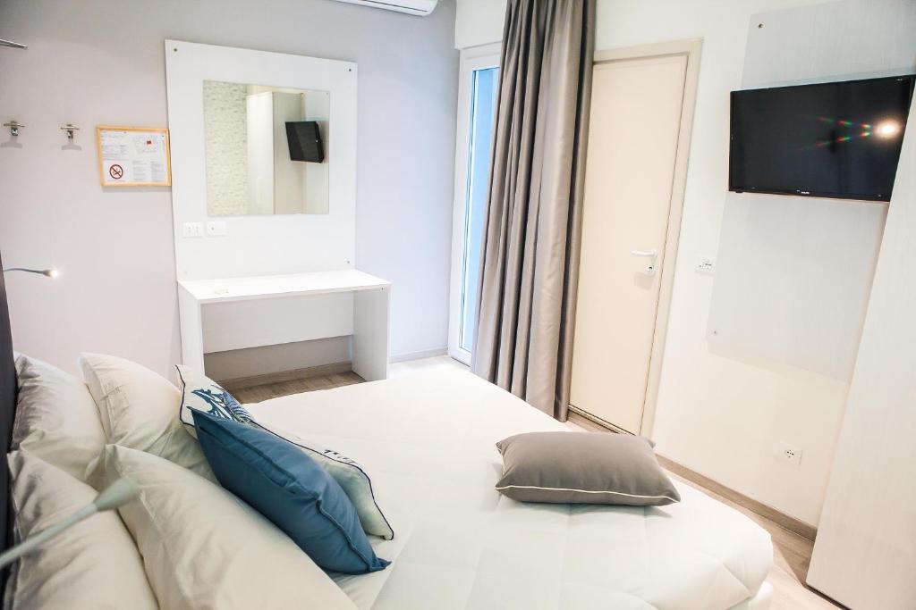 Postel nebo postele na pokoji v ubytování Hotel Veliero