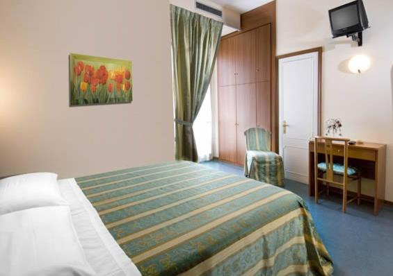 Giường trong phòng chung tại Hotel Acerboli