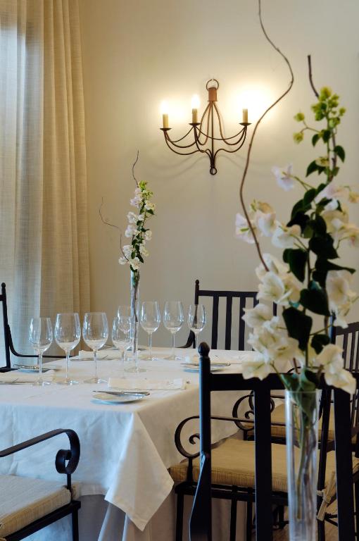 a table with wine glasses and white flowers on it at Villa VIK - Hotel Boutique in Arrecife