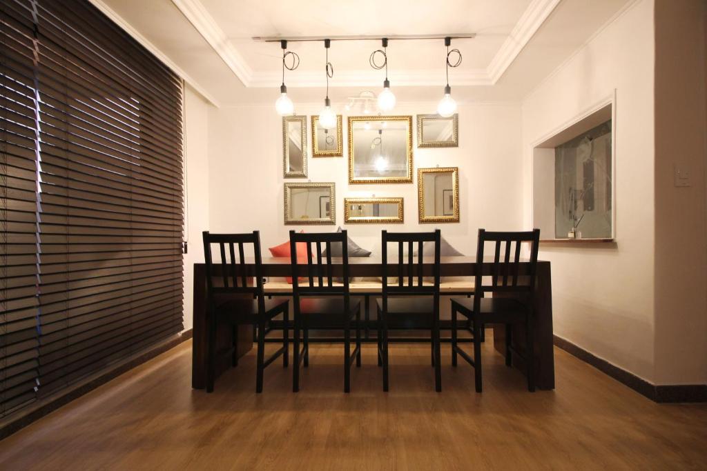 a dining room with a black table and chairs at MTT Guest House in Seoul