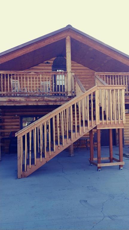 a wooden deck of a cabin with a porch at Wonder Inn Outback in Panguitch