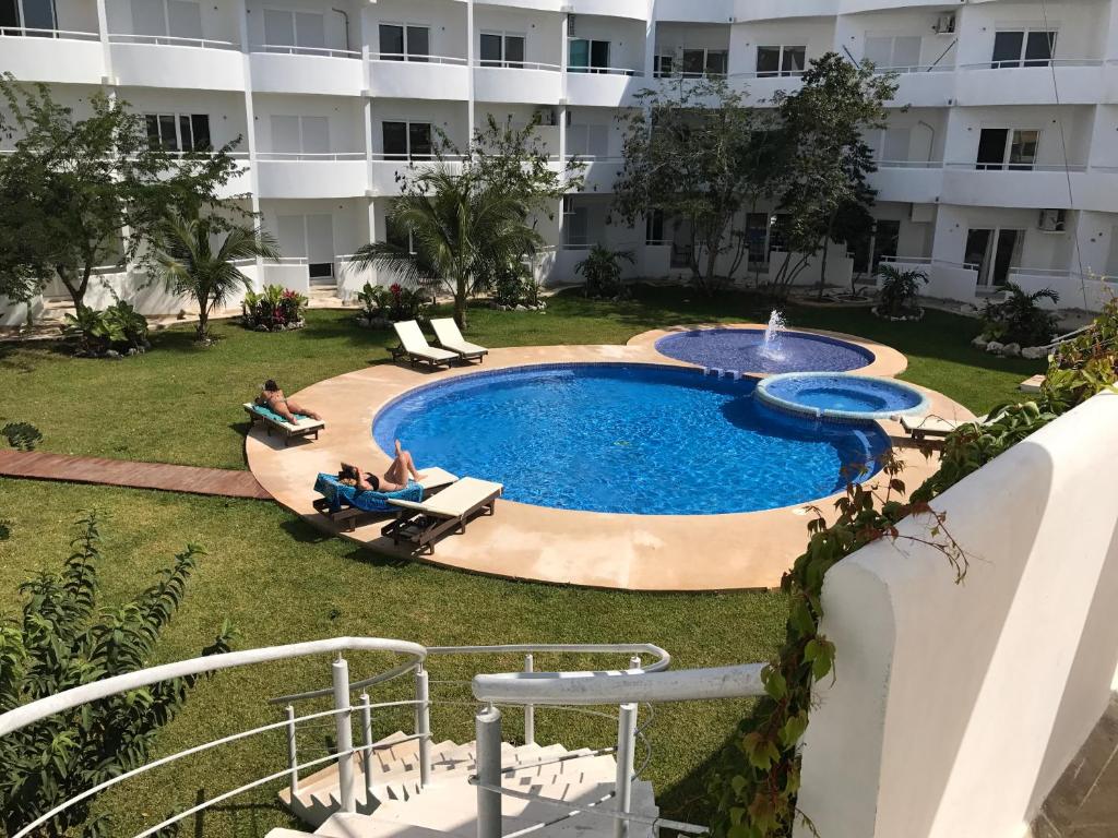 an image of a swimming pool in front of a building at Luxury Suites at Suites Cozumel in Cozumel