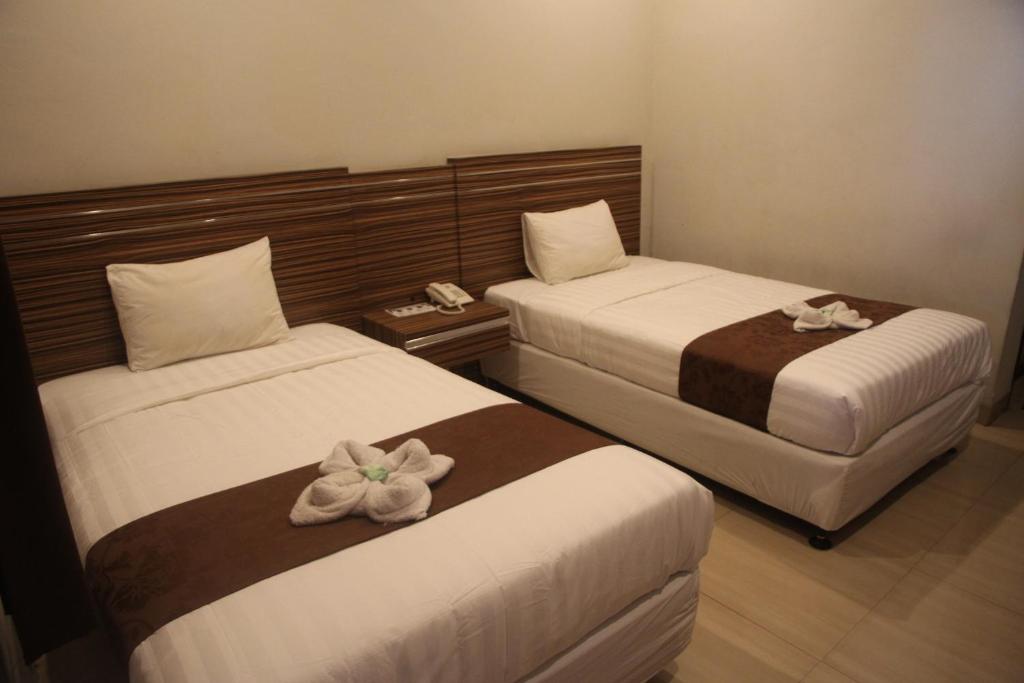 Postel nebo postele na pokoji v ubytování Palapa Hotel