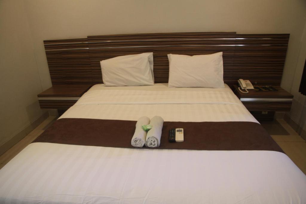 Postel nebo postele na pokoji v ubytování Palapa Hotel