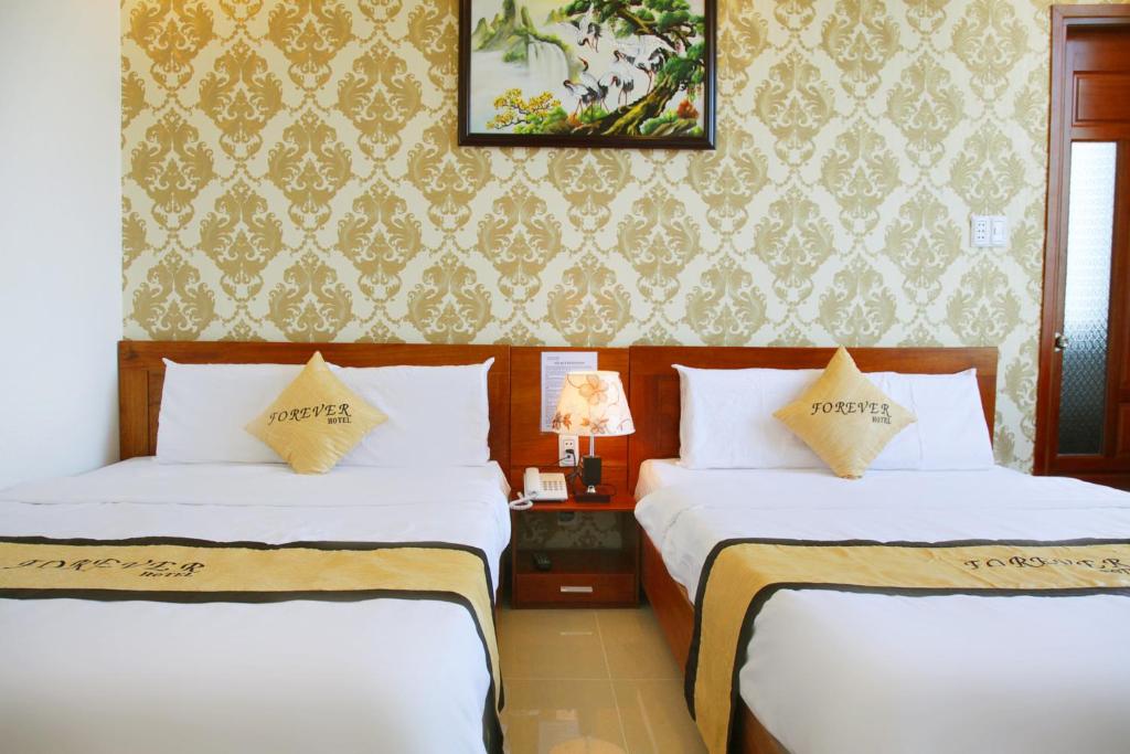 Postel nebo postele na pokoji v ubytování Forever Hotel