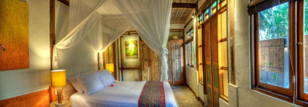 Postel nebo postele na pokoji v ubytování Villas SAMALAMA Gili Trawangan