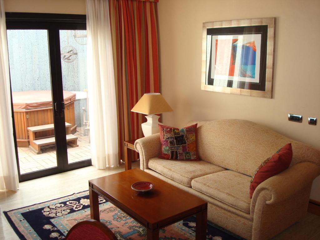 a living room with a couch and a table at Villa VIK - Hotel Boutique in Arrecife