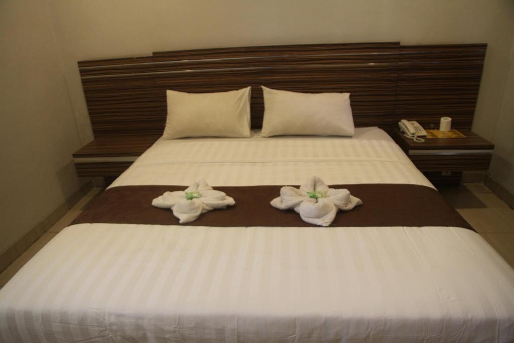 Postel nebo postele na pokoji v ubytování Palapa Hotel