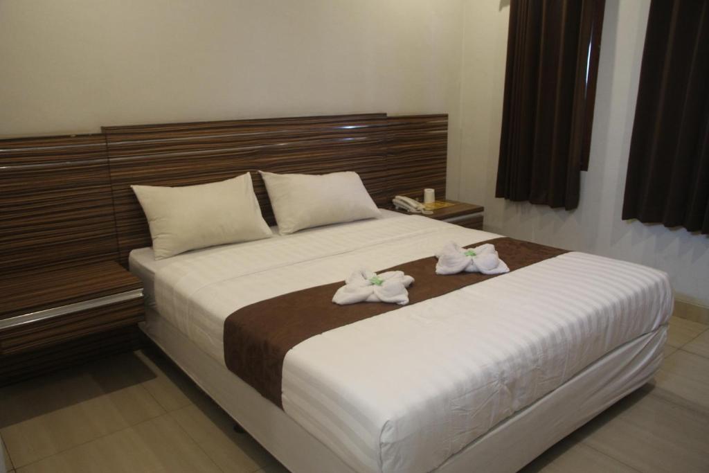 Postel nebo postele na pokoji v ubytování Palapa Hotel