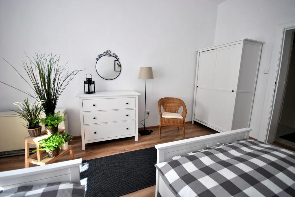 a bedroom with a bed and a dresser and a mirror at Oliva Stay in Gdańsk