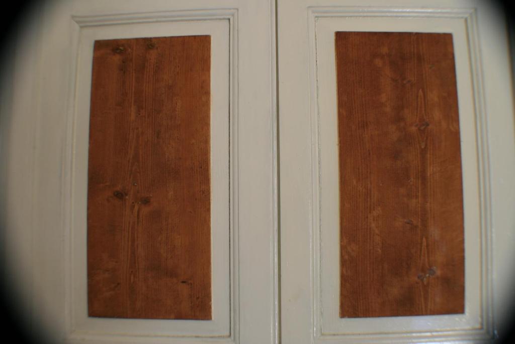 two wood panels on the side of a wall at Casolare Capitolo in Cisternino
