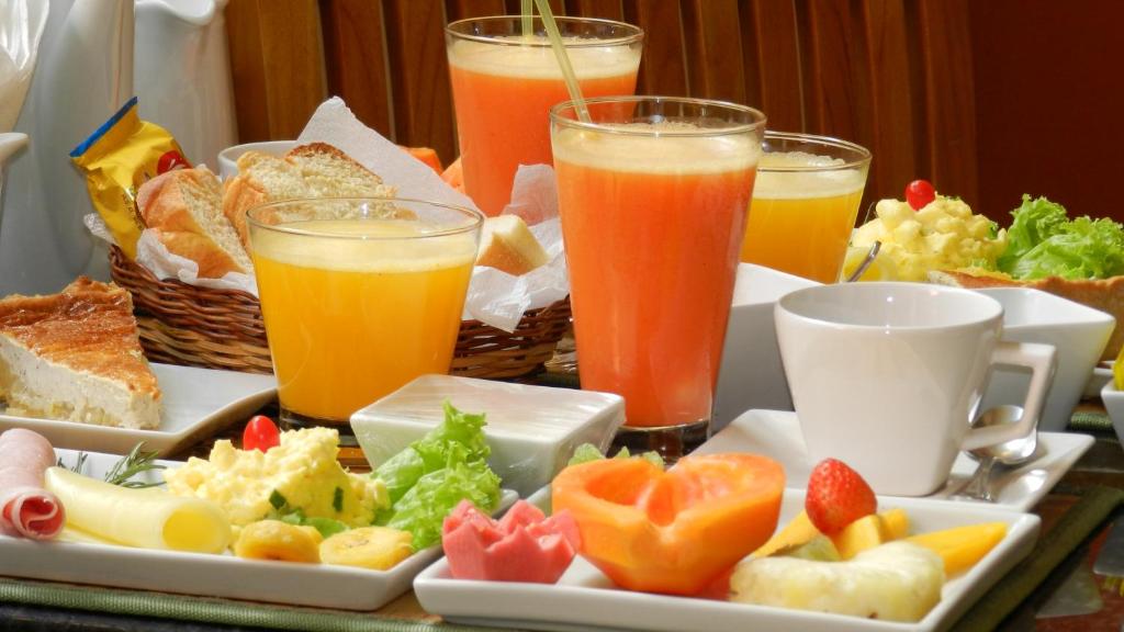 a tray of food with fruit and drinks on a table at Hotel Casa do Amarelindo in Salvador