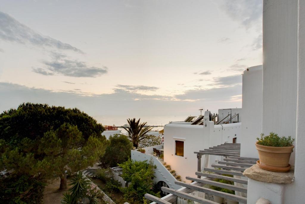 a view from the side of a white building with stairs at Studios & Suites Rania in Mikonos