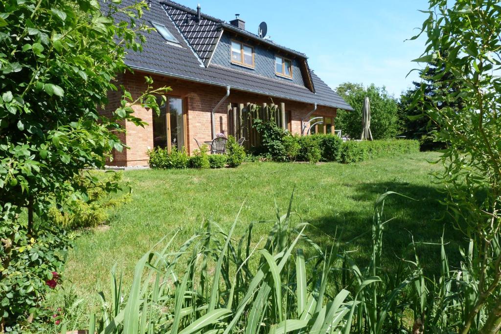 a house with a grassy yard in front of it at Ferienwohnung Familie Görtler in Graal-Müritz