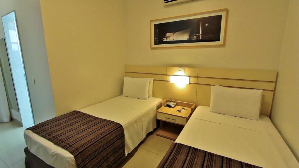Postel nebo postele na pokoji v ubytování Pampulha Lieu Hotel