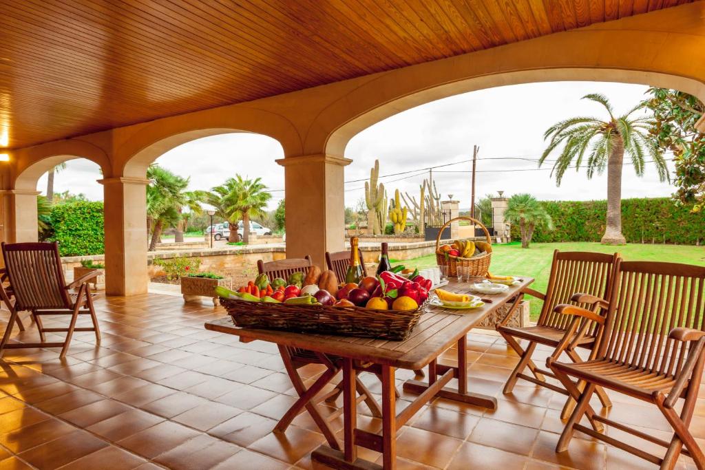 a table with a basket of fruit on a patio at Villa Son Ferriol in Palma de Mallorca