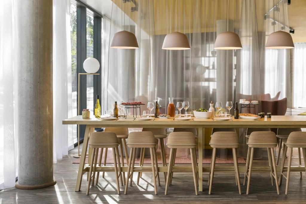 a dining room table with chairs and tables at Okko Hotels Paris Porte De Versailles in Paris
