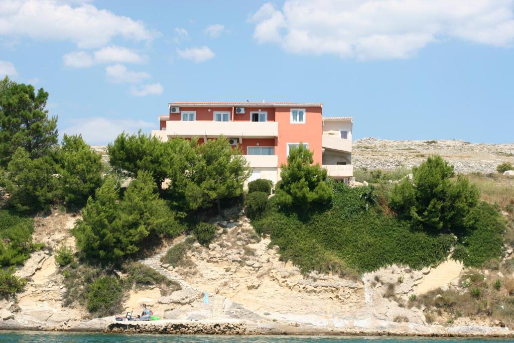 a house on an island in the water at Apartments Sara in Vlašići