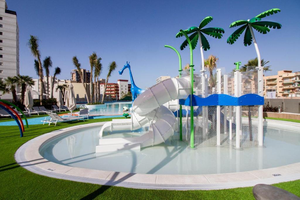 a water slide in a park with palm trees at ESTIMAR Calpe Suitopia in Calpe