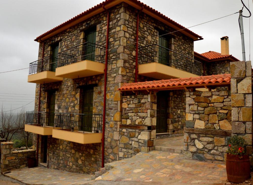 a stone house with two balconies on the side of it at Messana in Messini