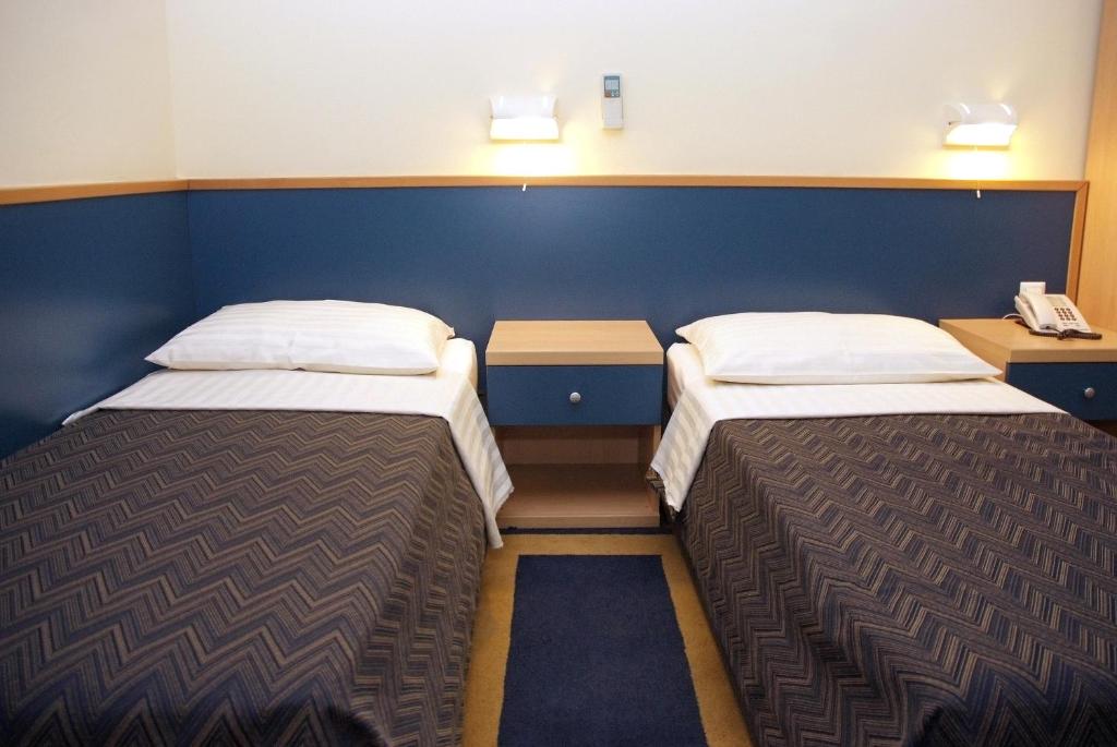 Postel nebo postele na pokoji v ubytování Hotel Cubic