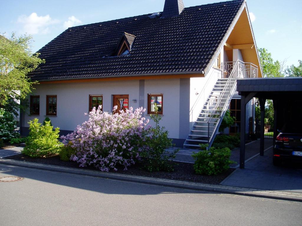 a small white house with a black roof at Ferienwohnung Haus Giesner in Kappel