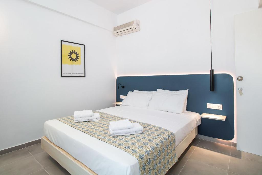a bedroom with a bed with two towels on it at Kappa Apartments in Faliraki