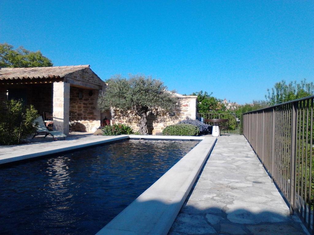 a swimming pool in front of a house at Le Grangeon in Cruis