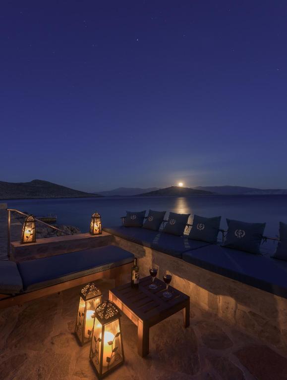 a living room with a couch and a table at night at Admiral's House in Halki