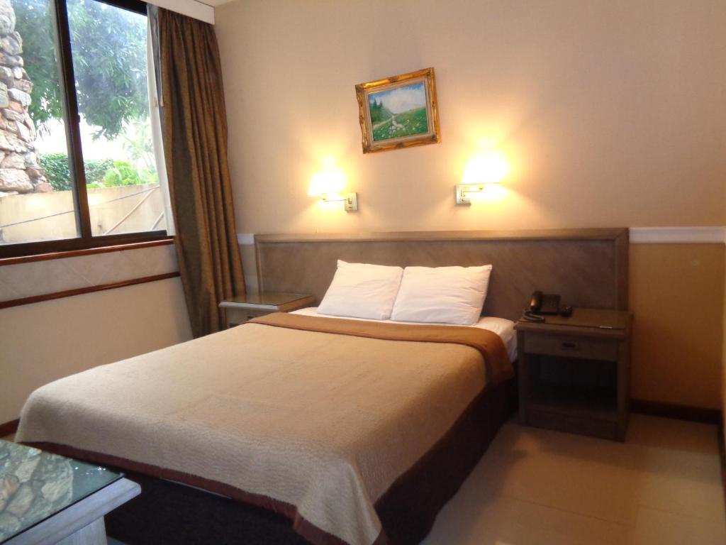 Postel nebo postele na pokoji v ubytování Premier Hill Suites Hotel